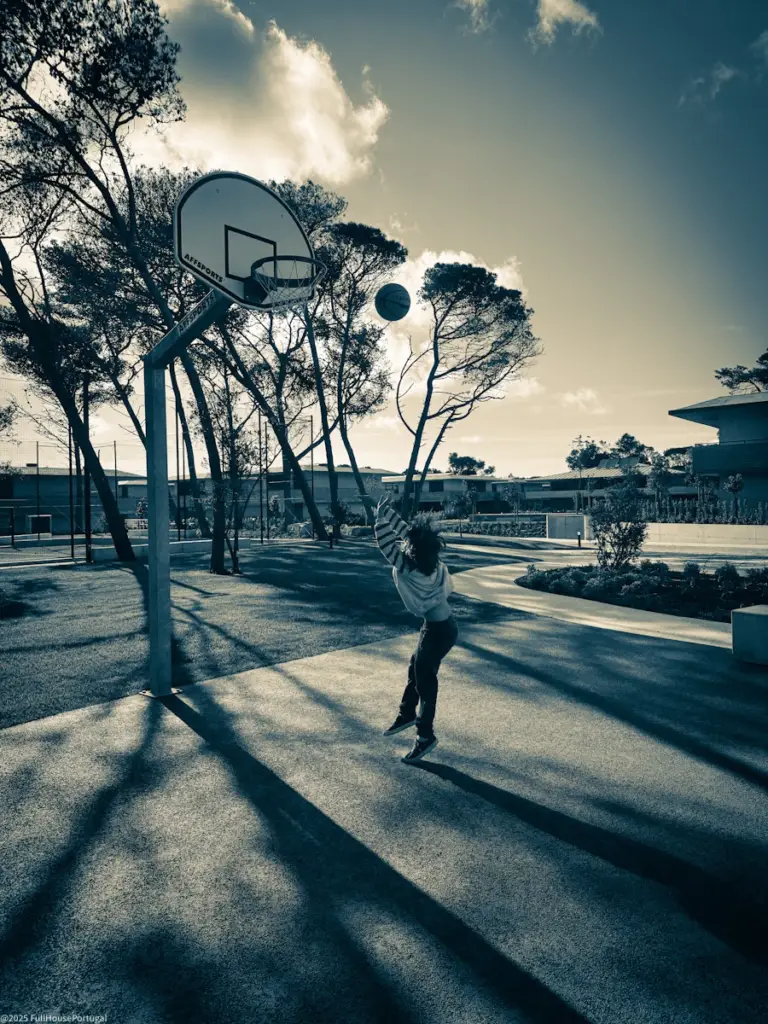 Boy playing basketball in Portugal. Condominium living.