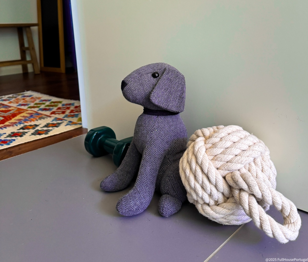 Cute dog-shaped and rope doorstops holding a door open in a Portuguese rental to stop it slamming from the breeze.